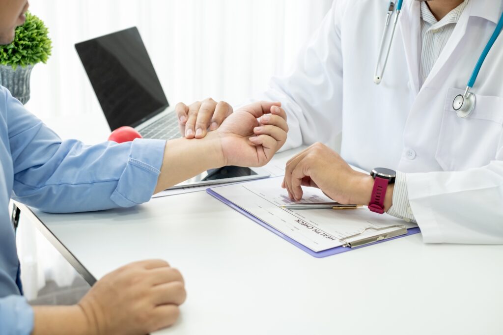 Male doctor are examining the patient's wrist pain.